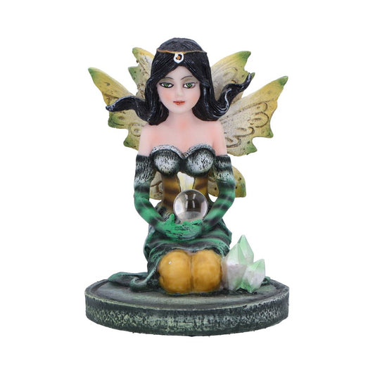 Standing gracefully at approximately 9cm tall, Jade mesmerizes with her serene pose, delicately holding a glass ball on her knee, while adorned in vibrant green and yellow striped clothing. The base of the figure is adorned with shimmering crystals, adding an extra touch of magic to this enchanting piece. She’s a perfect addition to any fairy collection.