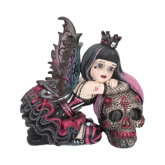 Created by Nemesis Now, this dark Fantasy figurine, Lolita, is part of the Gothic Little Shadows range. Wearing a crown bearing a skull, Lolita stares at you longingly, her red-pink-and-blue tinged wings casually open behind her. She kneels to the side, her red and black skirt flaring up behind her, as she leans on a large skull.