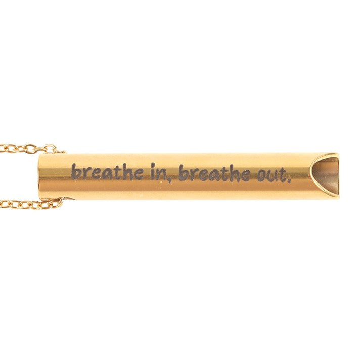 Gold necklace with a cylindrical pendant inscribed with 'breathe in, breathe out.' on a white background.