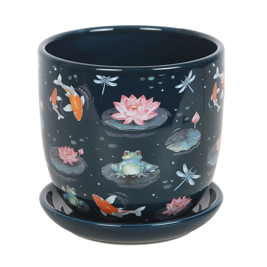 Nestle your cherished plants within this enchanting pond-themed pot, accompanied by a matching saucer. Adorned with mystical frogs, dragonflies, lily pads, and koi fish, it creates a magical sanctuary for your treasured greenery..
