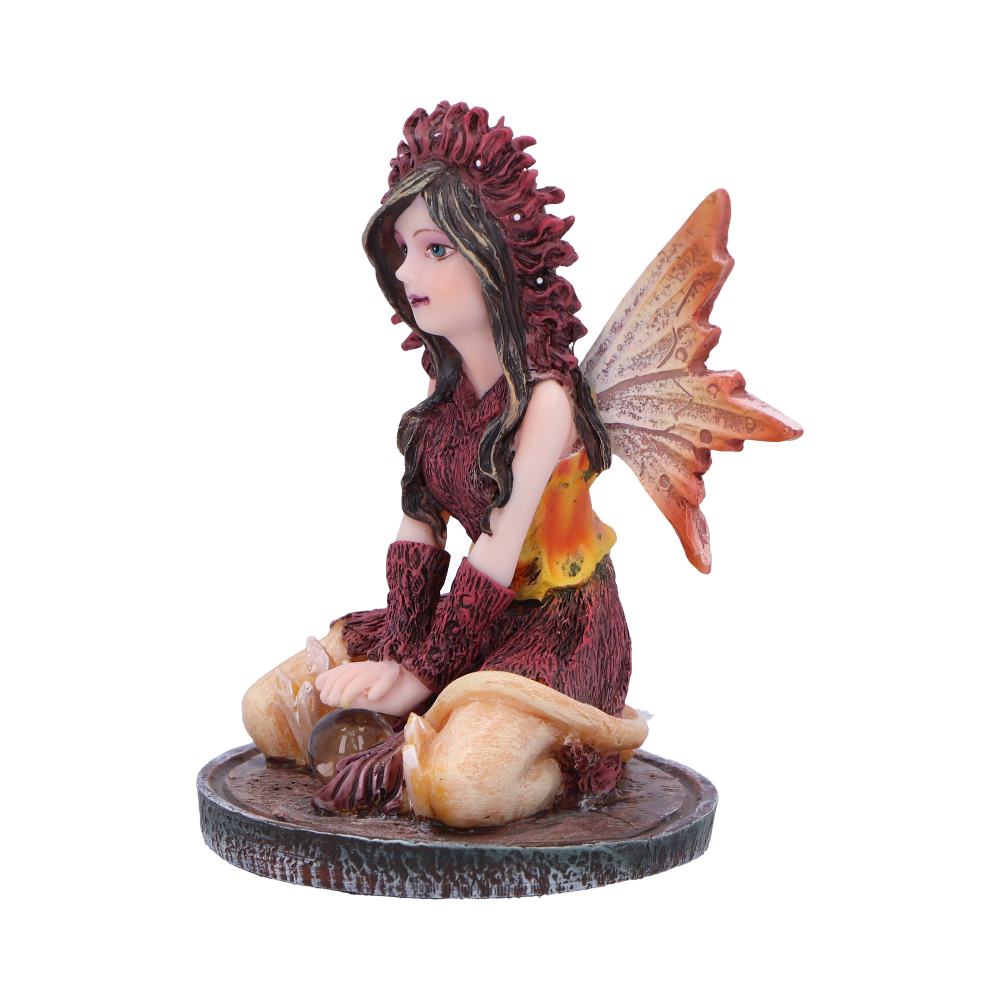 Fairy figurine with red hair and orange wings on a white background