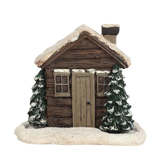 This enchanting log cabin incense cone burner conjures the perfect ambiance for a mystical winter evening. Light the cone, and watch as smoke gently curls from the chimney, mimicking a cozy fire flickering inside. Designed exclusively for incense cones, some may take up to 10 minutes to release their full smoky magic. Dimensions: H10cm x W10.5cm x D7.5cm. Packaged: H11.5cm x W11.3cm x D7.5cm. Embrace the warmth of this tiny hearth in your sacred space.