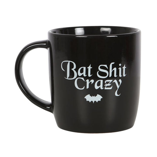 Feel a little batty before your morning brew? Let the world know to approach with caution until you’ve had your potion with the Bat Shit Crazy Mug — a darkly funny addition to any gothic kitchen or witchy coffee collection.

Featuring bold “Bat Shit Crazy” text and a playful nod to your untamed pre-caffeine energy, this mug perfectly balances humour with attitude. Its sleek black ceramic finish and comfortable handle make it a daily essential for witches, goths, and night creatures alike.

With a 340ml capa