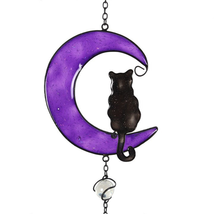 Embrace the enchanting whispers of the Black Cat Windchime, a mystical blend of hand-crafted metal, glass, and resin shaped into a captivating black cat design. Ethically sourced and imbued with protective energy, this windchime is perfect for both indoor sanctuaries and outdoor gardens. As gentle breezes stir its delicate chimes, invite harmony and subtle magic into your space. Measuring 50cm tall, it’s a striking talisman that balances beauty and spirit, making it an essential charm for any witch’s garden