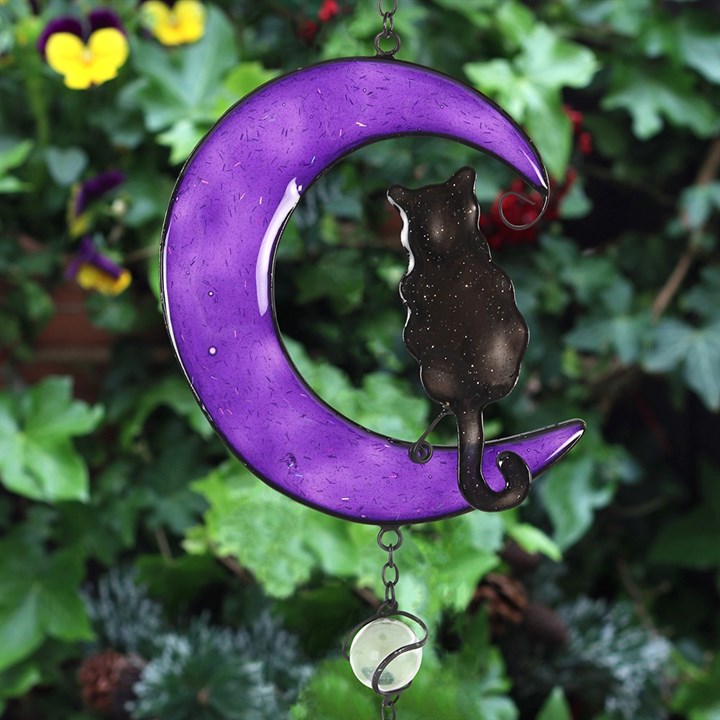 Embrace the enchanting whispers of the Black Cat Windchime, a mystical blend of hand-crafted metal, glass, and resin shaped into a captivating black cat design. Ethically sourced and imbued with protective energy, this windchime is perfect for both indoor sanctuaries and outdoor gardens. As gentle breezes stir its delicate chimes, invite harmony and subtle magic into your space. Measuring 50cm tall, it’s a striking talisman that balances beauty and spirit, making it an essential charm for any witch’s garden