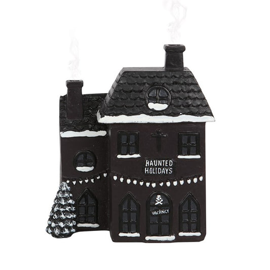 Step into a realm where shadows dance and spirits linger with this haunted holiday house incense cone burner. This eerie black abode offers a bewitching twist on festive décor, creating a perfect gothic sanctuary for your incense cones. Place a cone inside and watch as ghostly smoke curls from its twin chimneys, casting an enchanting spell. Dimensions: H14cm x W12cm x D7cm; Packaged: H17cm x W15cm x D9cm. Embrace the mystical charm of your haunted holiday retreat.