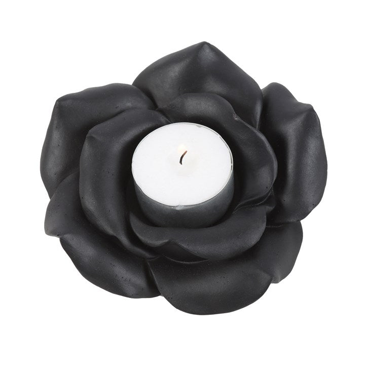 This enchanting black rose tealight holder adds a touch of timeless beauty to any space. Made of resin and intricately crafted, this tealight holder creates a romantic ambience and accommodates a standard single tealight. Never leave a burning candle unattended. Do not burn for longer than 30 minutes at a time and never allow the candle to burn all the way down to the base.