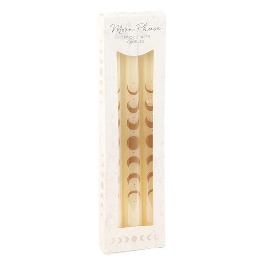 Call upon the quiet glow of the moon with this Set of 3 Off White Moon Phases Taper Dinner Candles. Each elegant taper bears the phases of the lunar cycle, a sacred symbol of transformation, intuition, and eternal renewal. Witches and mystics have long revered the waxing, full, and waning moon as a guide for spellwork, divination, and life’s cycles — to light these candles is to invite the moon’s wisdom into your home.