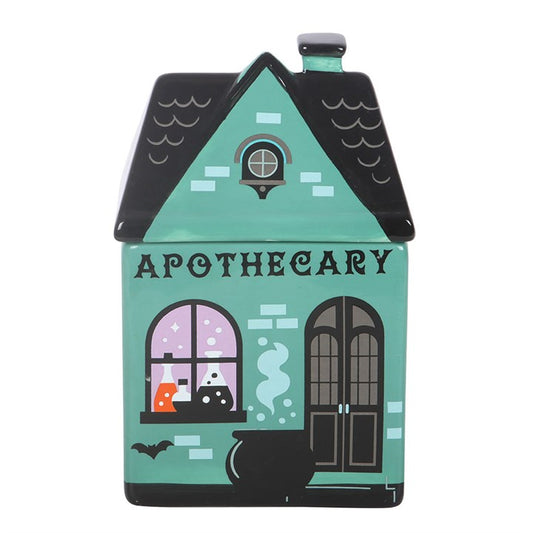 Bring a touch of mystical charm to your home with this ceramic oil burner, designed to look like a vintage apothecary shop. With its detailed storefront complete with bubbling cauldron and colourful potions, it is perfect for diffusing your favorite autumn scents while adding a spooky touch to your shelves. Always remove the lid whilst in use. Recommended for use with fragrance oil diluted with water.