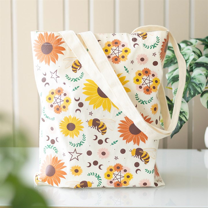 Sustainably carry summer essentials wherever you go with this Polycotton tote bag. Adorned with a Summer Solstice-inspired print of sunflowers, bees, pentagrams, and moon phases. The durable Polycotton canvas tote bag includes ample space for carrying as an everyday bag or for shopping.