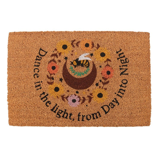 Welcome the season with this natural Summer Solstice-inspired coir doormat. Featuring a crescent moon. bee, and sunflower design with the uplifting text "Dance in the light from day into night", this doormat adds a rustic touch to any entryway while celebrating the vibrant energy of the solstice. The perfect doormat to only display indoors or under sheltered porches during the warmer months. Please note that the printed design may fade when left outside in extreme weather.