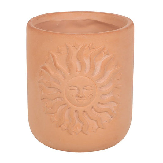 Infuse your sanctuary with mystical charm using this terracotta plant pot adorned with a radiant sun motif. Its warm, earthy hue harmonizes effortlessly with any setting, creating a sacred space for your beloved plants or succulents. Place it on a windowsill, shelf, or balcony to invite a gentle glow of nature’s magic into your home or garden.