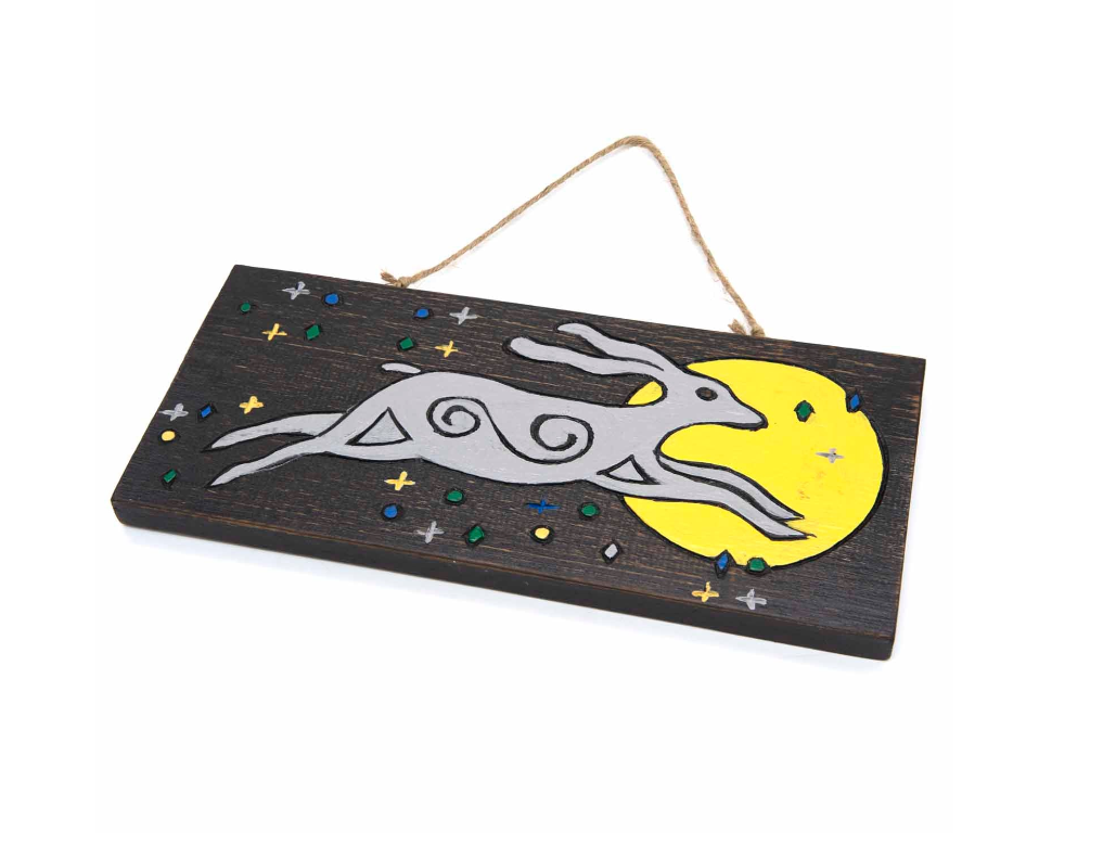 Hares have long held sacred significance in ancient spiritual traditions worldwide. In pagan lore, spotting a hare gazing at the moon symbolizes growth, renewal, fresh starts, and blessings. This enchanting wall plaque, hand-painted and Fairtrade from Indonesia, features sturdy twine for effortless hanging indoors or outdoors. Measuring approximately 30cm by 14cm, it’s a mystical charm to invite positive energy into your space.