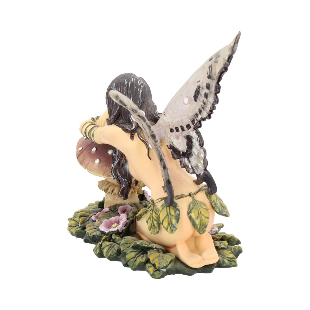 Fairy figurine with wings and a mushroom on a white background