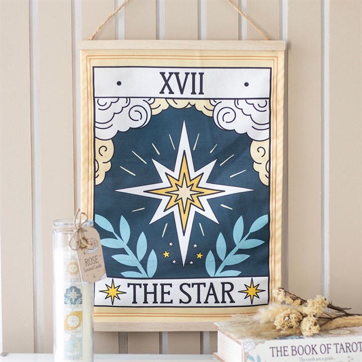 Framed tarot card print titled 'The Star' on a neutral wall.