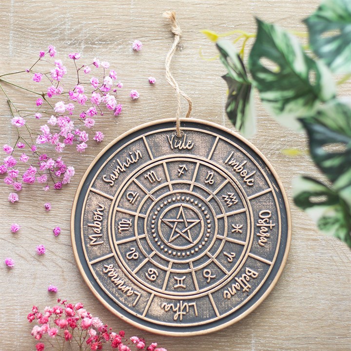 This hanging terracotta plaque features a bronze-effect finish and an engraved Wheel of the Year design, symbolising the cyclical rhythm of nature’s seasons. Ideal for decorating spiritual spaces or marking sabbats throughout the year.