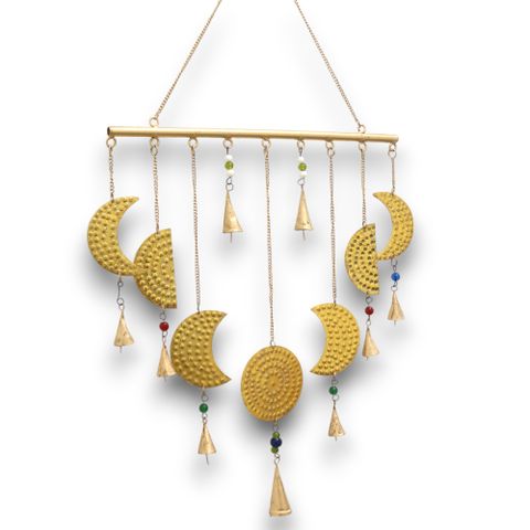 Crafted in India, this enchanting brass chime depicts the moon’s phases with exquisite detail, bringing a mystical aura to any room. Measuring 43x40 cm, it beautifully captures each lunar stage, embodying the eternal cycle of life and rebirth. Delicate brass bells add a gentle, melodic whisper that dances with the breeze, inviting calm and spiritual harmony into your space.

Let this moon phase chime become a sacred addition to your spiritual sanctuary. Each brass crescent and full moon holds the energy of 
