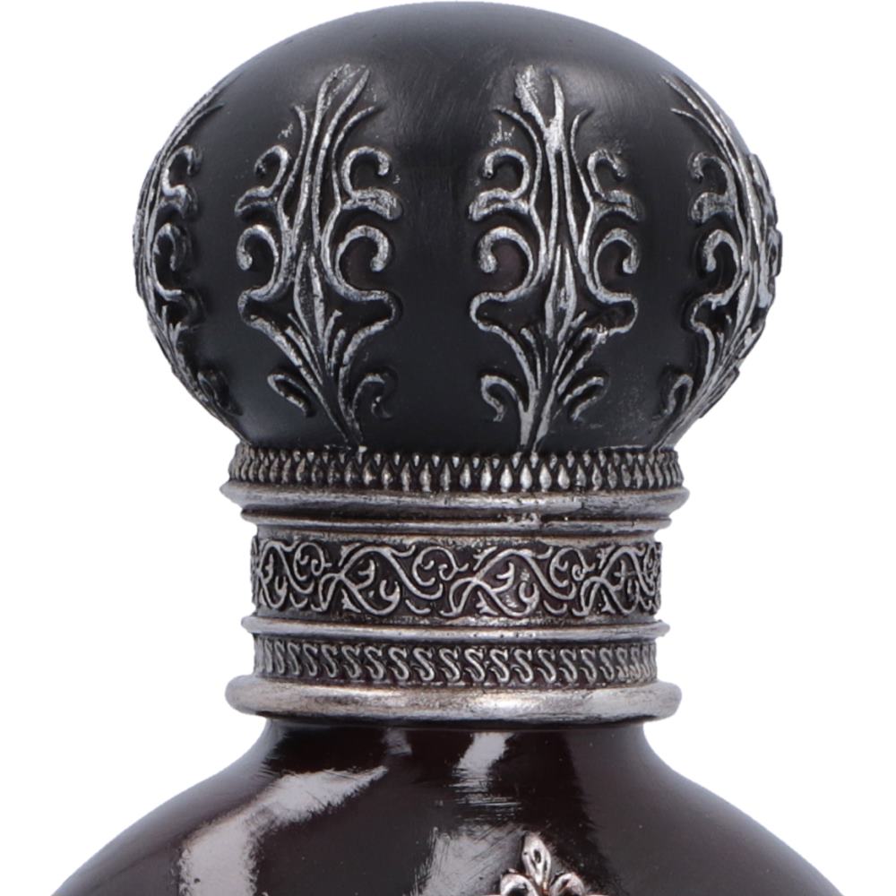 Close-up of a dark glass bottle neck with an ornate black and silver filigree cap on a white background.
