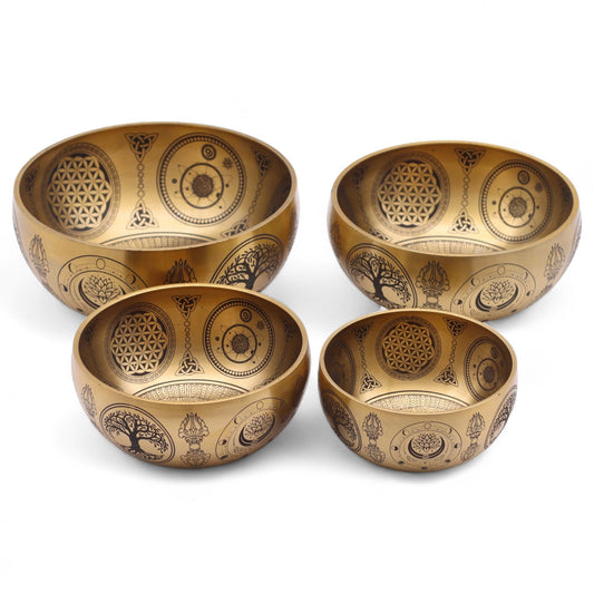 Four brass bowls with intricate engravings on a white background