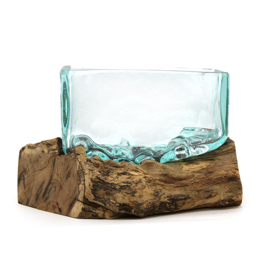Celebrate the harmony of nature and craft with our Molten Glass Tank on Wood with Stand – Medium Bowl. Handcrafted in Bali from recycled glass and Balinese Gamal wood, each piece is a unique work of art. The molten glass is hand-blown and shaped while hot, then gently rested over natural wood, where it cools and hardens to form a perfect organic fit.