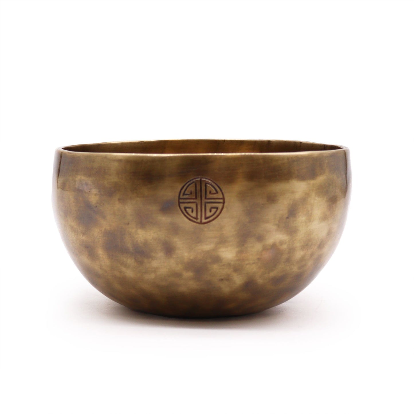 Bronze singing bowl with a circular emblem on a white background