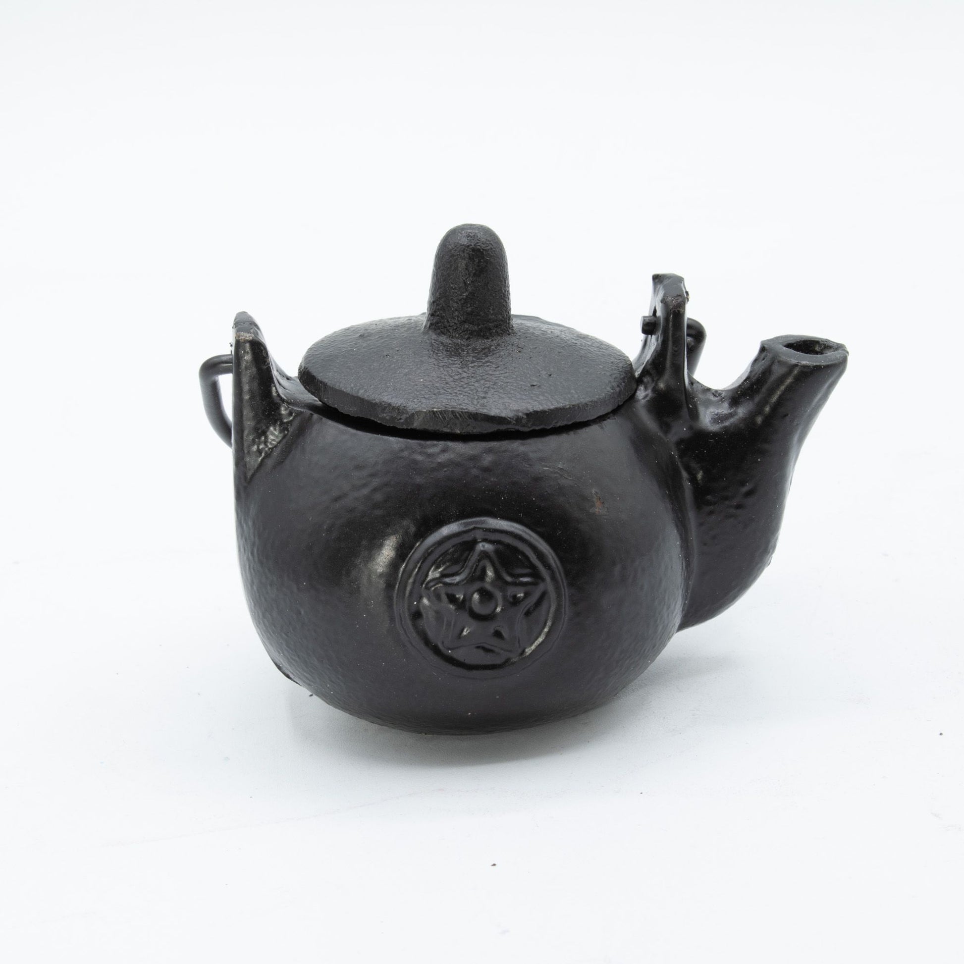 A darkly elegant ritual pot forged from solid cast iron, crowned with a protective lid and commanding side handle. The pentagram embossed upon its surface marks it as a vessel for serious craft—perfect for burning sacred herbs, charcoal, or incense during your most potent workings. Compact yet commanding, this 8x8x10cm cauldron sits perfectly on altar or shelf, radiating gothic presence. The cast iron construction holds heat steadily, containing ash and smoke between rituals while its fitted lid keeps your 