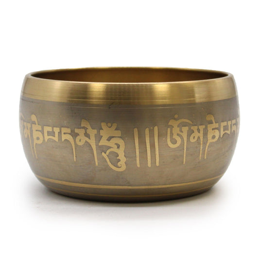 Bronze singing bowl with engraved text on a white background