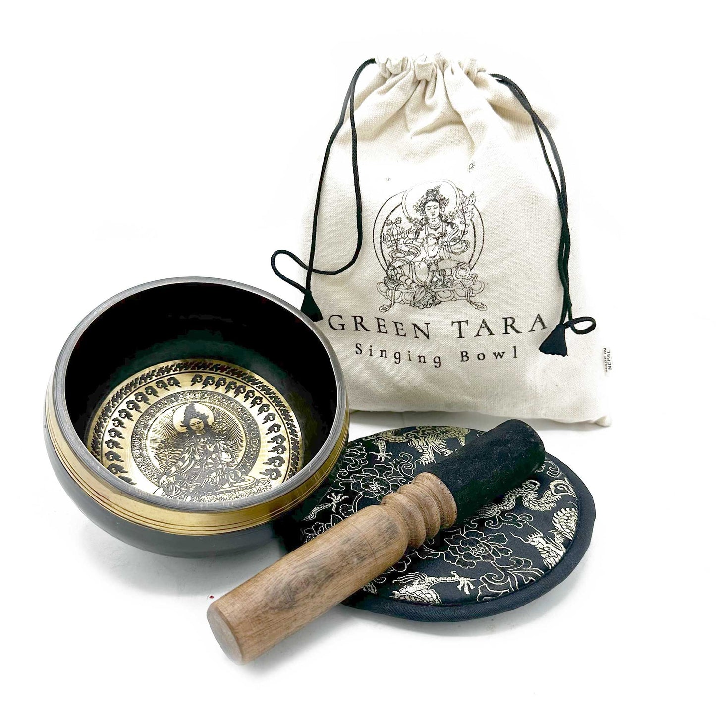 Singing bowl set with decorative mat, mallet, and carrying bag on a white background