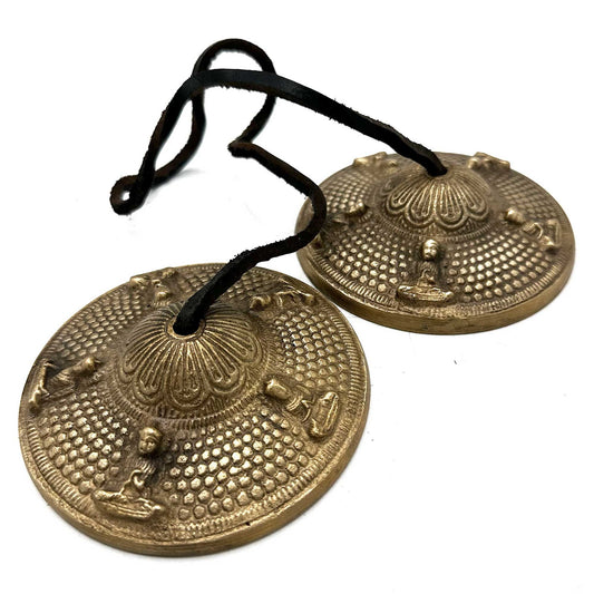 Awaken harmony and higher awareness with the Tibetan Tingsha – Five Buddhas, a sacred pair of hand-cast cymbals crafted by skilled Tibetan artisans. Measuring approximately 9.5cm in diameter, each cymbal is engraved with the Five Buddhas, symbols of enlightenment, compassion, and spiritual truth.

When gently struck together, the pure, resonant tone carries through the air — clearing negative energy, deepening meditation, and aligning the mind with the divine. These Tingsha are ideal for ritual work, prayer