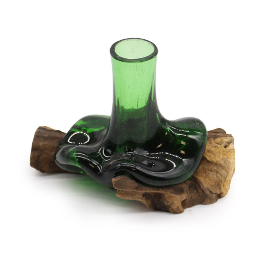 Bring a touch of eco-friendly charm to your home with our Mini Flower Vase on Wood, crafted from molten recycled beer bottles and a natural wooden base. Handmade in Indonesia, each vase is completely unique, shaped by skilled artisans who transform discarded glass into a piece of living art. The flowing green glass atop warm wood makes it a perfect bohemian accent for any shelf, table, or sacred space.

In boho folklore, upcycled glass embodies renewal and transformation—turning something old into something