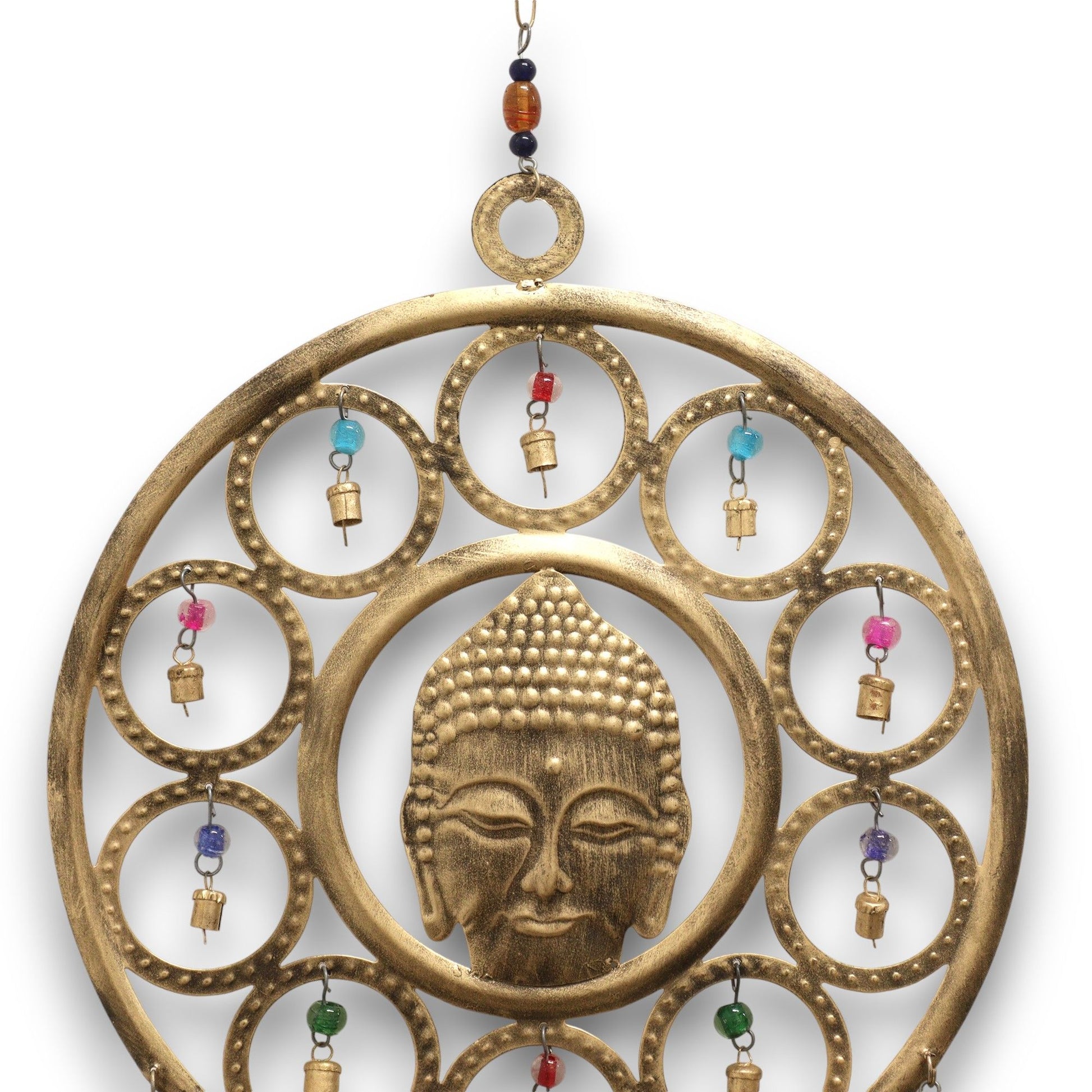 Enrich your space with peace, presence, and sacred resonance through these Indian Chimes featuring a beautifully crafted large Brass Buddha Face. Measuring 36cm, this striking piece radiates calm and spiritual clarity, with the serene Buddha visage framed by delicate circular accents and vibrant, colourful beads that amplify its visual charm.

Fifteen polished brass bells hang gracefully below, each producing a soft, harmonious tone that brings balance and tranquillity to any environment. Ideal for meditati