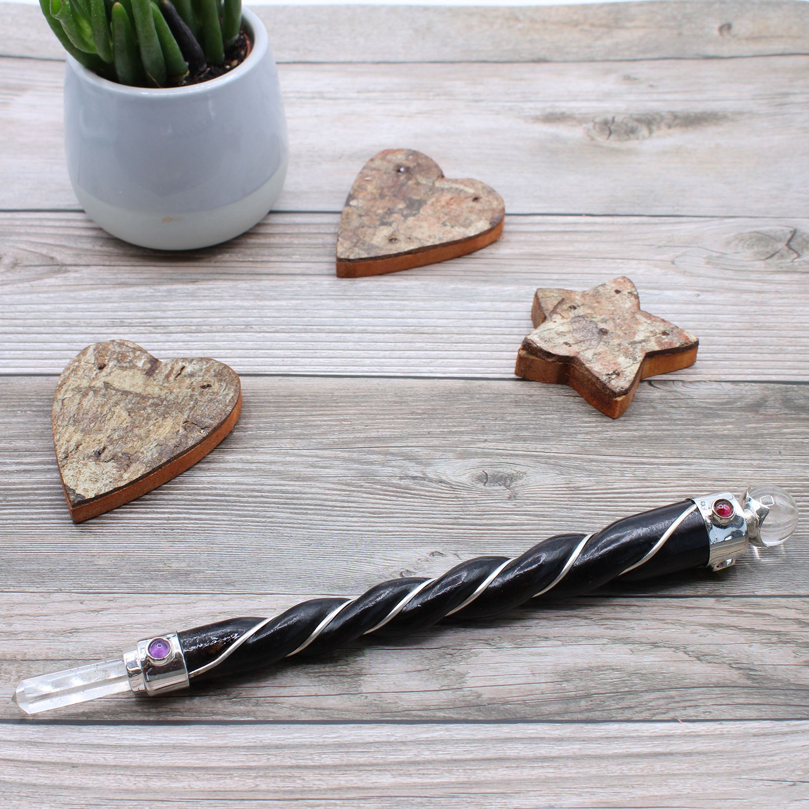 Let love flow through every layer of your being with the Twisted Healing Wand – Silver Rose Quartz Sphere. Handcrafted with intention, this sacred tool features a spiraling form that channels energy gracefully and a silver-set Rose Quartz sphere that glows with the soft vibration of compassion and emotional healing.

Rose Quartz is the stone of unconditional love, soothing the heart and nurturing your connection to self, others, and the divine. Its gentle energy helps dissolve emotional wounds, restore trus