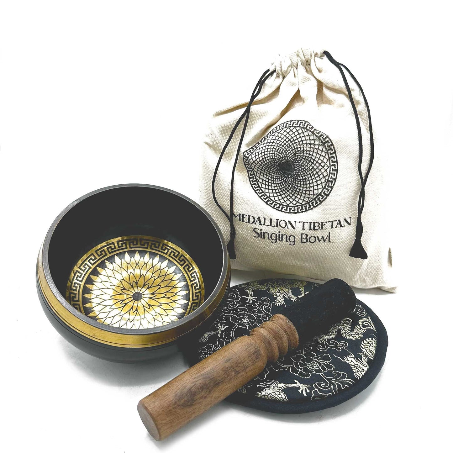 Tibetan singing bowl set with decorative lid, wooden striker, and carrying bag on a white background