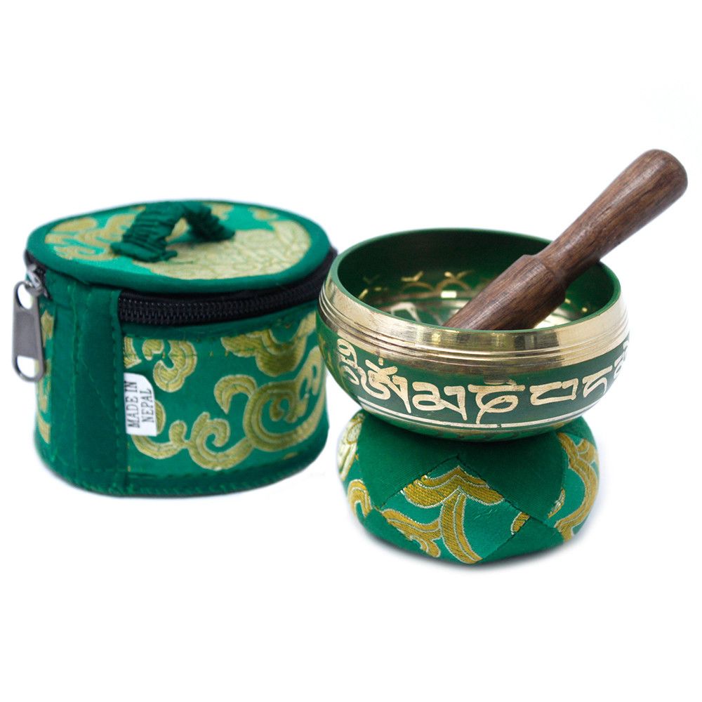 Green singing bowl set with decorative case on a white background