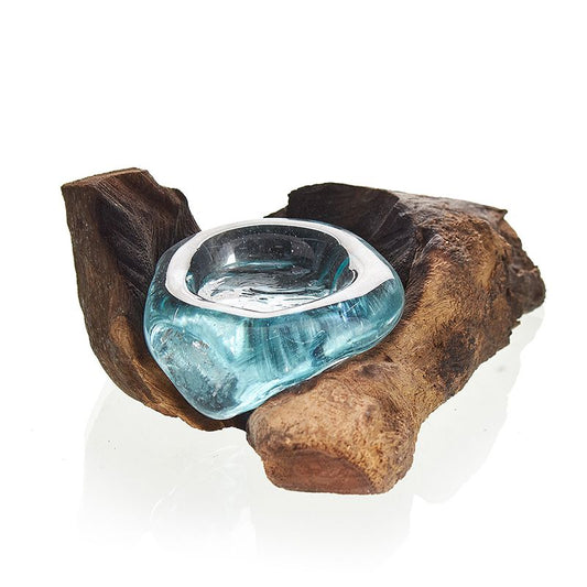 Illuminate your space with the soulful glow of our Molten Glass on Wood Candle Holder, a handcrafted treasure made in Bali from recycled glass and Gamal wood. Each piece is a unique fusion of nature and craft: molten glass is hand-blown and carefully relaxed over a piece of Gamal root, where it hardens into a perfect organic fit.

In Balinese tradition, molten glass on wood symbolizes balance and harmony—the meeting of the natural and the man-made, the earthy and the spiritual. Lighting a candle in this hol
