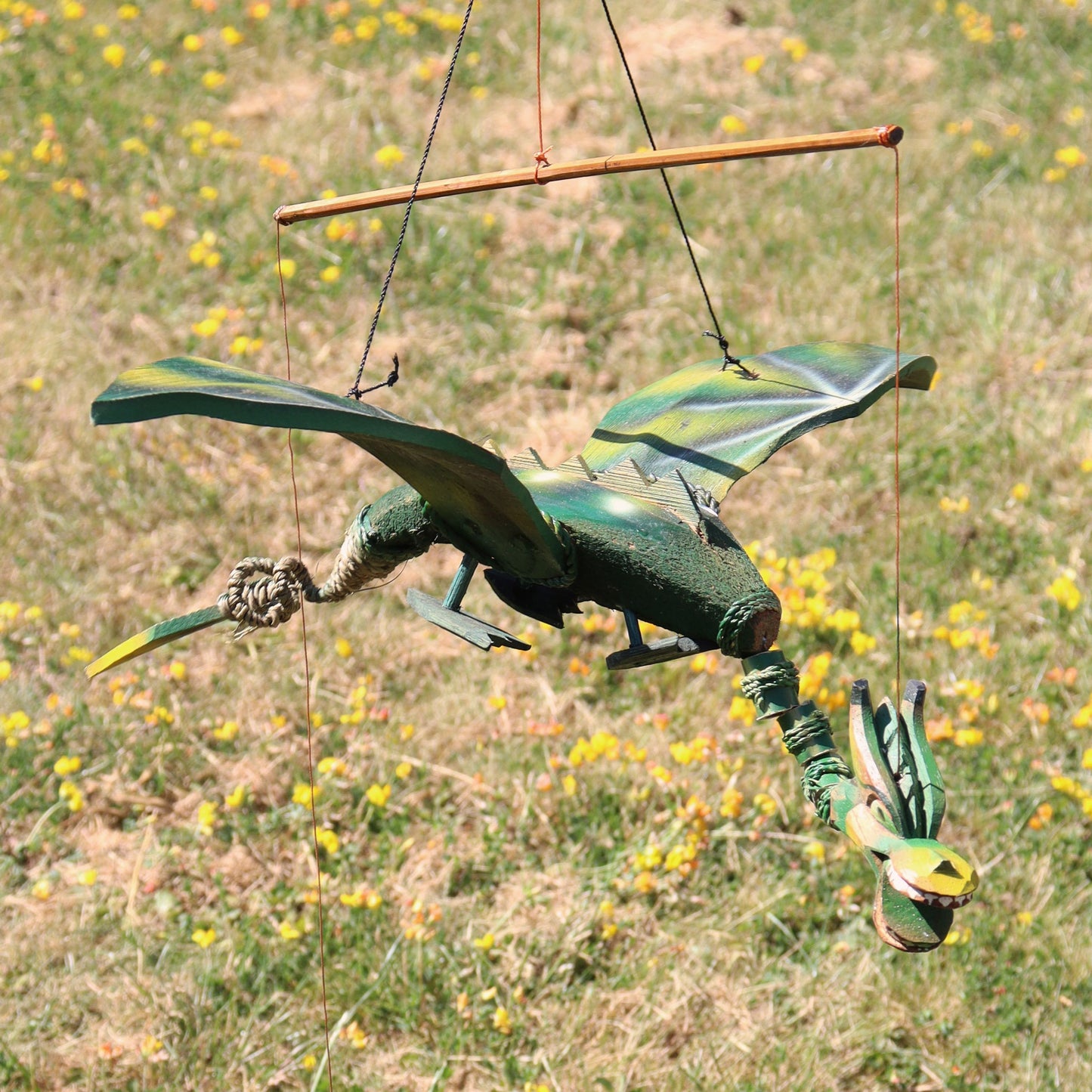 Green coconut dragon hanging mobile with 37cm wingspan. Unique garden or home dragon decor that moves gently in the breeze.