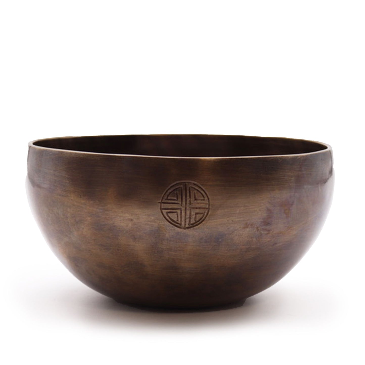 Bronze singing bowl with a circular emblem on a white background