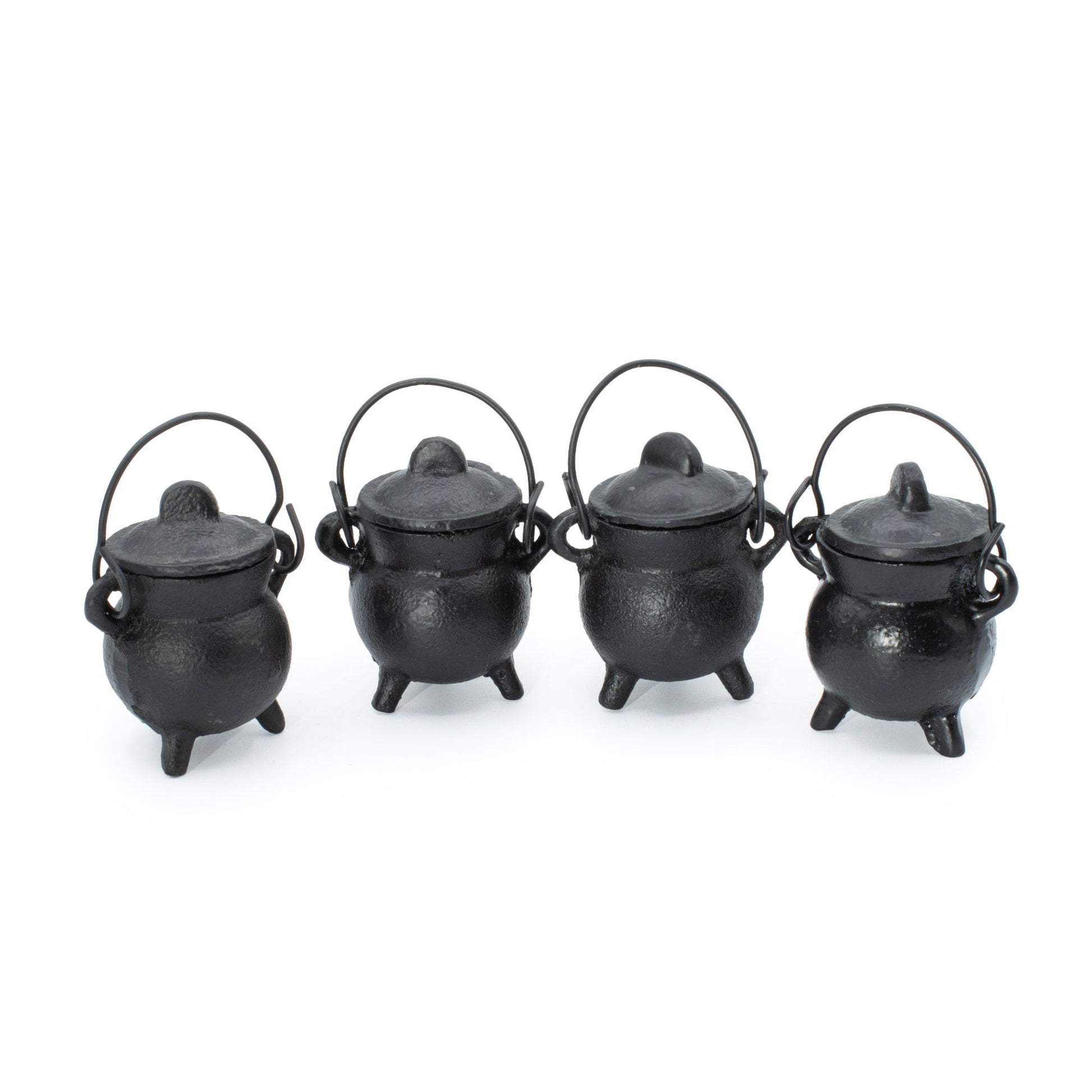 Small, simple, and brimming with gothic charm. This set of four extra small cast iron cauldrons captures the essence of witchy tradition in a perfectly petite size. Perfect for burning incense, herbs, or cones, they nestle beautifully on shelves, altars, or desks without demanding space. The sturdy three-leg base keeps them grounded and stable, while the fitted lid traps ash and contains the mystique. Each cauldron features a small handle for effortless repositioning between your sacred spaces. A versatile,