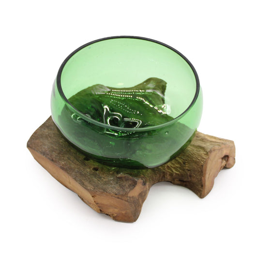 Infuse your space with eco-friendly elegance with our Wide Bowl on Wood, handcrafted from molten recycled beer bottles and set atop a natural wooden base. Each piece is handmade in Indonesia, making it a unique, one-of-a-kind creation. The flowing green glass paired with the rustic wood creates an earthy, organic aesthetic perfect for serving, displaying treasures, or as a decorative statement.