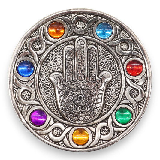 &nbsp;Measuring 11.5 cm, this piece is designed to accommodate standard incense sticks while adding a touch of elegance and meaning to any space.

Featuring the iconic Hamsa symbol, renowned for its protective qualities, this holder is beautifully adorned with the vibrant colours of the seven chakras. Each chakra represents a different energy centre, promoting balance and well-being, making it an ideal addition for those focused on mindfulness and spiritual practices.