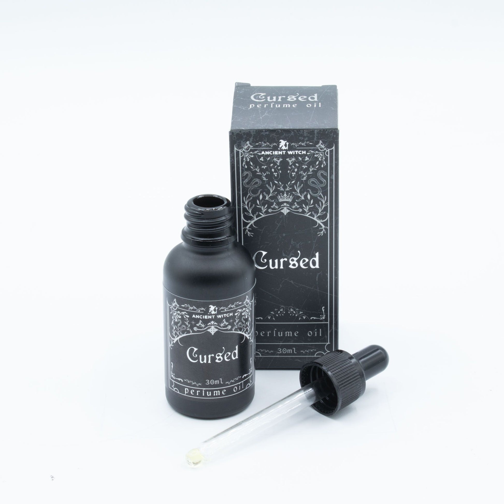 Cursed perfume oil by Ancient Witch. Spiced opening, smoky heart and warm amber base create a dark, seductive ritual fragrance.