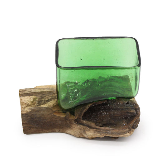 Add a touch of eco-boho charm with our Square Bowl on Wood, handcrafted from molten recycled beer bottles and set on a natural wooden base. Each piece is handmade in Indonesia, ensuring a unique, one-of-a-kind creation. The flowing green glass combined with the warm wood gives this bowl an organic, earthy elegance perfect for serving treats, displaying small treasures, or simply as a decorative accent.

In bohemian folklore, upcycled glass represents transformation and renewal, turning discarded materials i