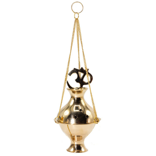 Bring harmony to your sacred space with this handcrafted Hanging Brass Incense Burner, adorned with the sacred Om symbol — a timeless mantra of peace, unity, and spiritual connection. Handmade in India from polished brass, it blends traditional craftsmanship with profound meaning.

Star-shaped cutouts allow the fragrant smoke to drift gently, creating a serene atmosphere perfect for meditation, rituals, yoga practice, or simple relaxation. The burner hangs gracefully from three golden chains with a central 