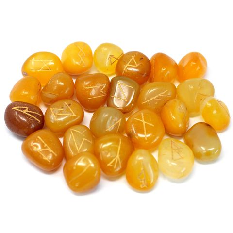 Unlock the secrets of the runes with this Yellow Onyx Rune Set in Pouch, a stunning 25-piece collection hand-carved from natural semi-precious stone. Each set includes 24 stones engraved with ancient rune symbols and one blank stone, all housed in a soft velvet pouch for safekeeping.

Yellow Onyx is a powerful stone known for promoting mental clarity, emotional balance, and inner strength. It helps dispel negative energy, boosts confidence, and supports wise decision-making—making it the perfect companion f