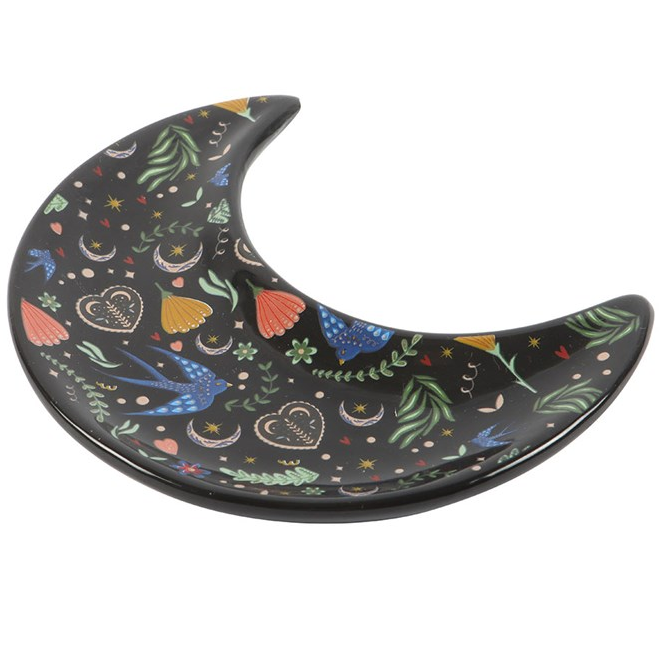 Decorative moon-shaped plate with colorful patterns on a white background