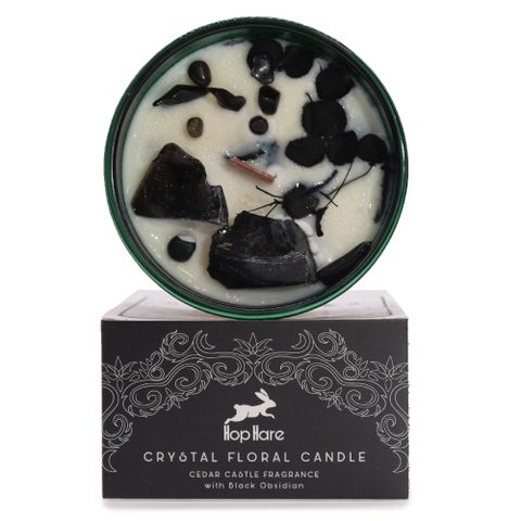 Enter a realm of enchantment with the Hop Hare Crystal Magic Flower Candle - The Knight of Swords. Infused with Black Obsidian gemstones and dried flowers, this candle reveals a tarot card that tells a mysterious tale. Its rich Cedar Castle scent blends vibrant orange and black pepper with smoky whiskey, leather, cedarwood, patchouli, and vanilla. Experience 22 hours of transformative magic and botanical charm with every burn.