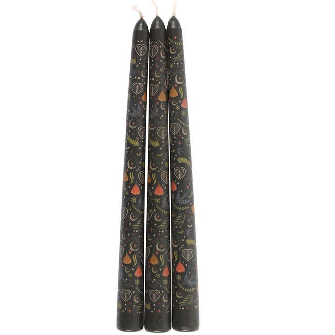 Three black candles with decorative patterns on a white background