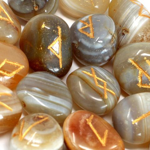 Unlock the wisdom of runic divination with this exquisite Banded Agate Rune Set. Each set includes 25 smooth, hand-carved stones: 24 engraved with sacred runic symbols and 1 blank stone, all beautifully housed in a soft pouch for safekeeping and ritual use.

Banded Agate is known for its grounding and stabilizing energy. It helps balance emotional, physical, and intellectual energy, and is believed to harmonize yin and yang—the positive and negative forces of the universe. Ideal for meditation, spiritual gu