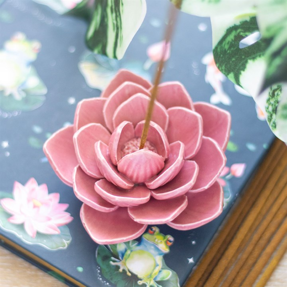 Pink ceramic water lily incense stick holder. Ideal for meditation, sacred rituals, calming home decor, and supporting incense sticks securely.