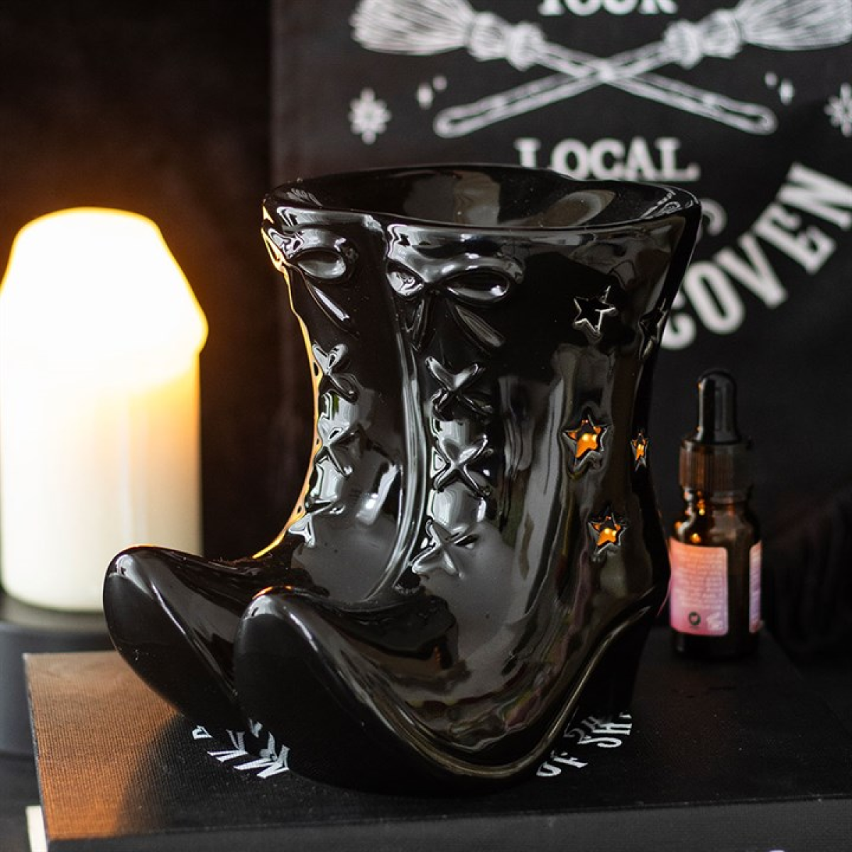 Black Witch Boots oil burner with star cut-outs. Use with fragrance oils for gothic, witchy décor, altars, or magical aromatic home ambiance.